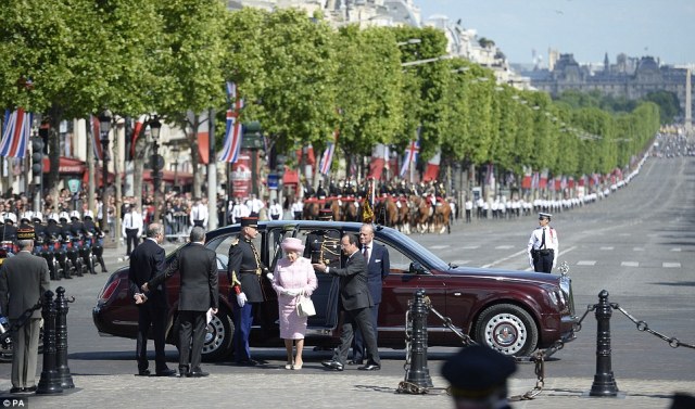 The streets of the Champs E'lysee were lined with well wishers as The Queen arrives the Arc de Triomphe and is greeted by the French President.