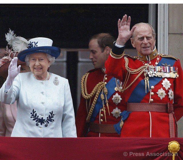 The Queen and The Duke of Edinburgh wave to the crowds from the balcony of Buckingham Palace following the Trooping the Colour parade, 14 June 2014.