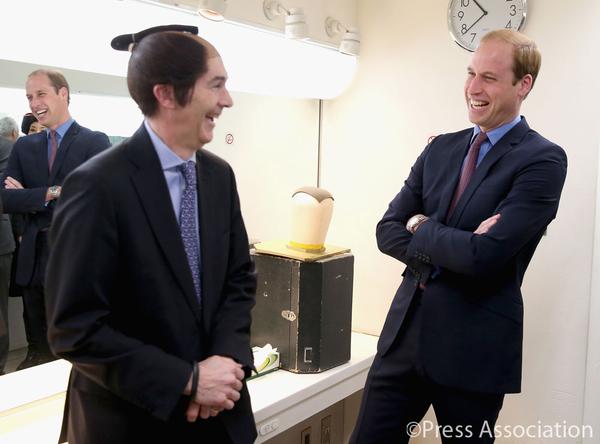 William contemplates wearing the wig which throws him into fit of giggles!