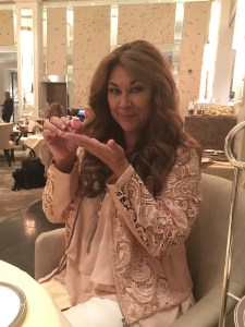 Marlise inspects a delicate strawberry macaron designed especially for Her Majesty's 90th birthday!